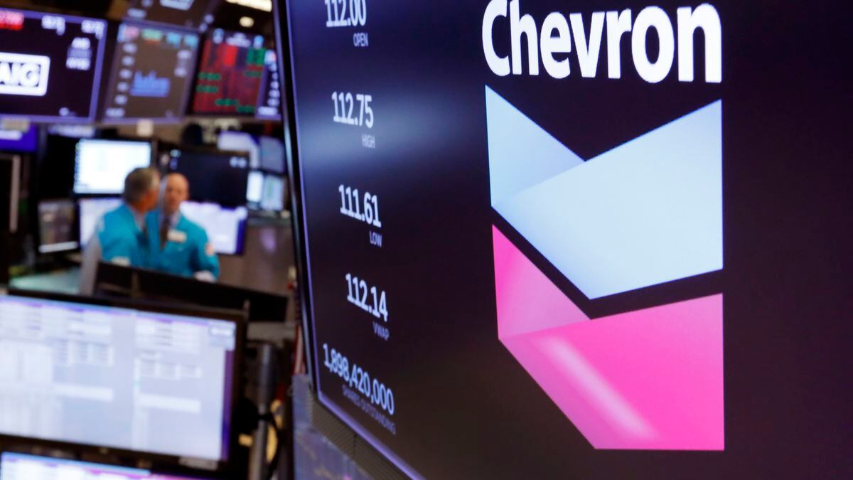 FILE - This Oct. 8, 2019, file photo the logo for Chevron appears above a trading post on the...