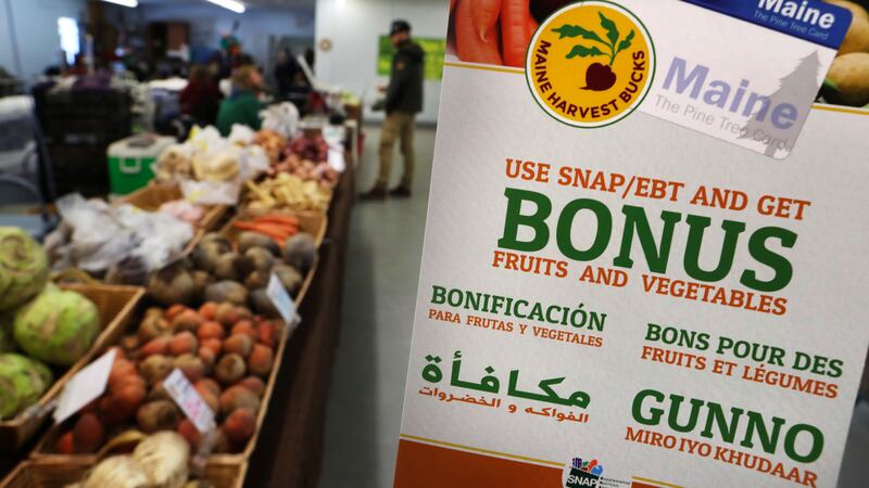 In this Friday, March 17, 2017, file photo, a sign advertises a program that allows food stamp...