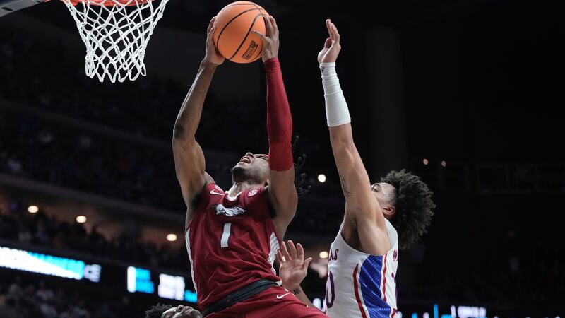 Arkansas' Ricky Council IV is fouled by tk10 during the final seconds of the second half of a...