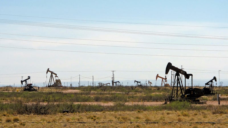 FILE - In this April 9, 2014, file photo, oil rigs stand in the Loco Hills field on U.S....