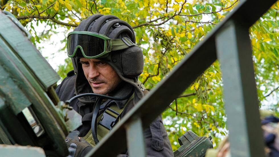 A Ukrainian serviceman sits on a T-80 tank that they claimed had been captured from the...
