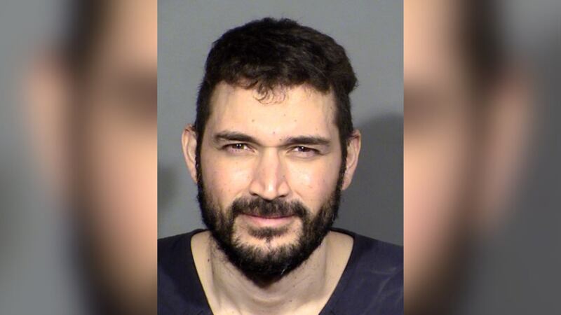 Christopher Vera, 33, was arrested after police said he struck a vehicle with an ax while a...