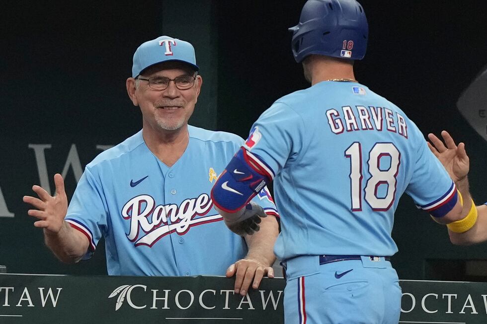 FILE - Texas Rangers manager Bruce Bochy, left, congratulates Mitch Garver after his solo home...