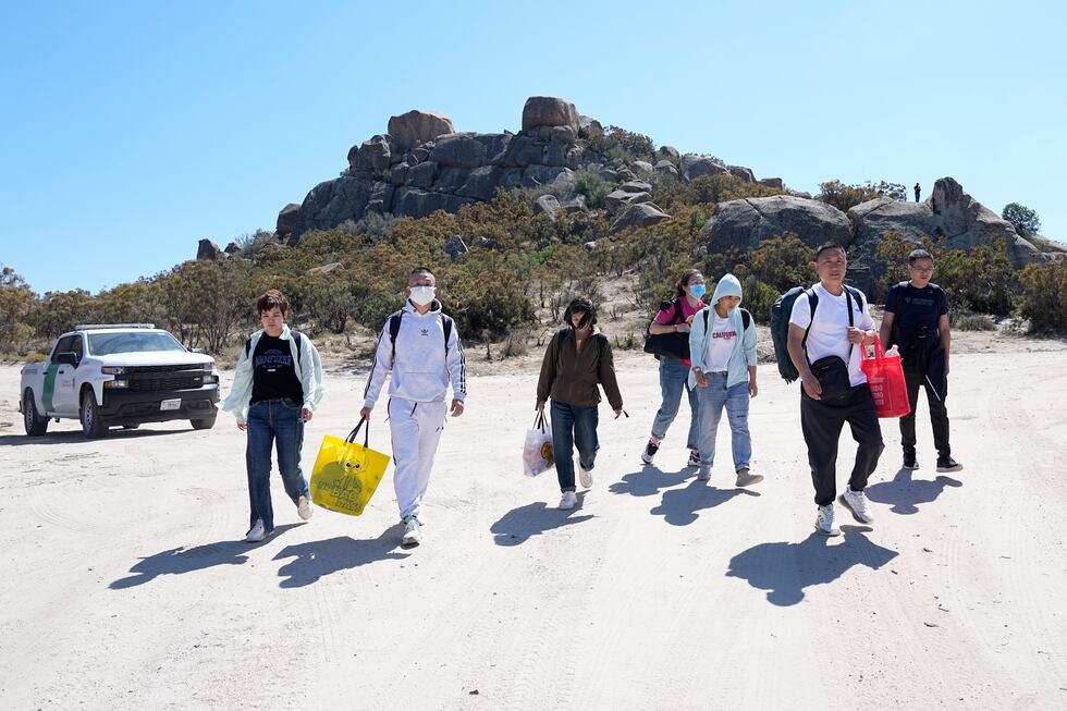 A group of asylum-seekers arrive to a makeshift camp after crossing the nearby border with...