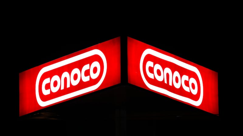 FILE - In this Oct. 25, 2011 file photo, a Conoco sign shines in Dallas. (AP Photo/LM Otero,...