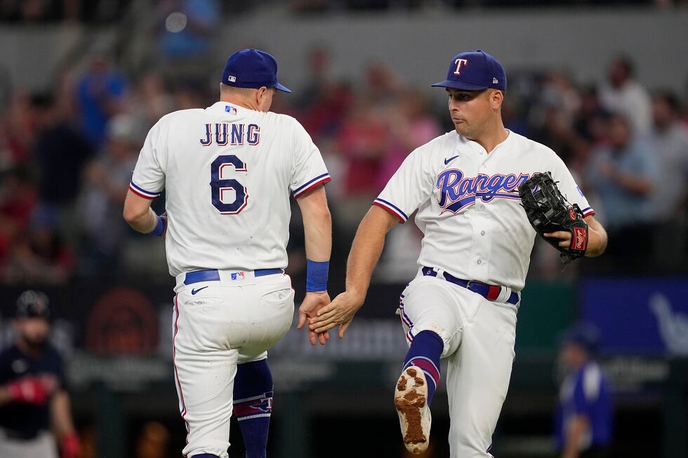 Texas Rangers' Josh Jung (6) and Nathaniel Lowe, right, celebrate their team's 15-5 win in a...