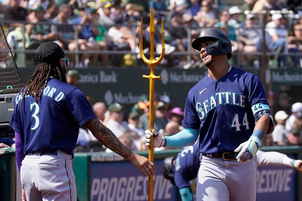 Seattle Mariners' Julio Rodriguez (44) is congratulated by J.P. Crawford (3) after hitting a...